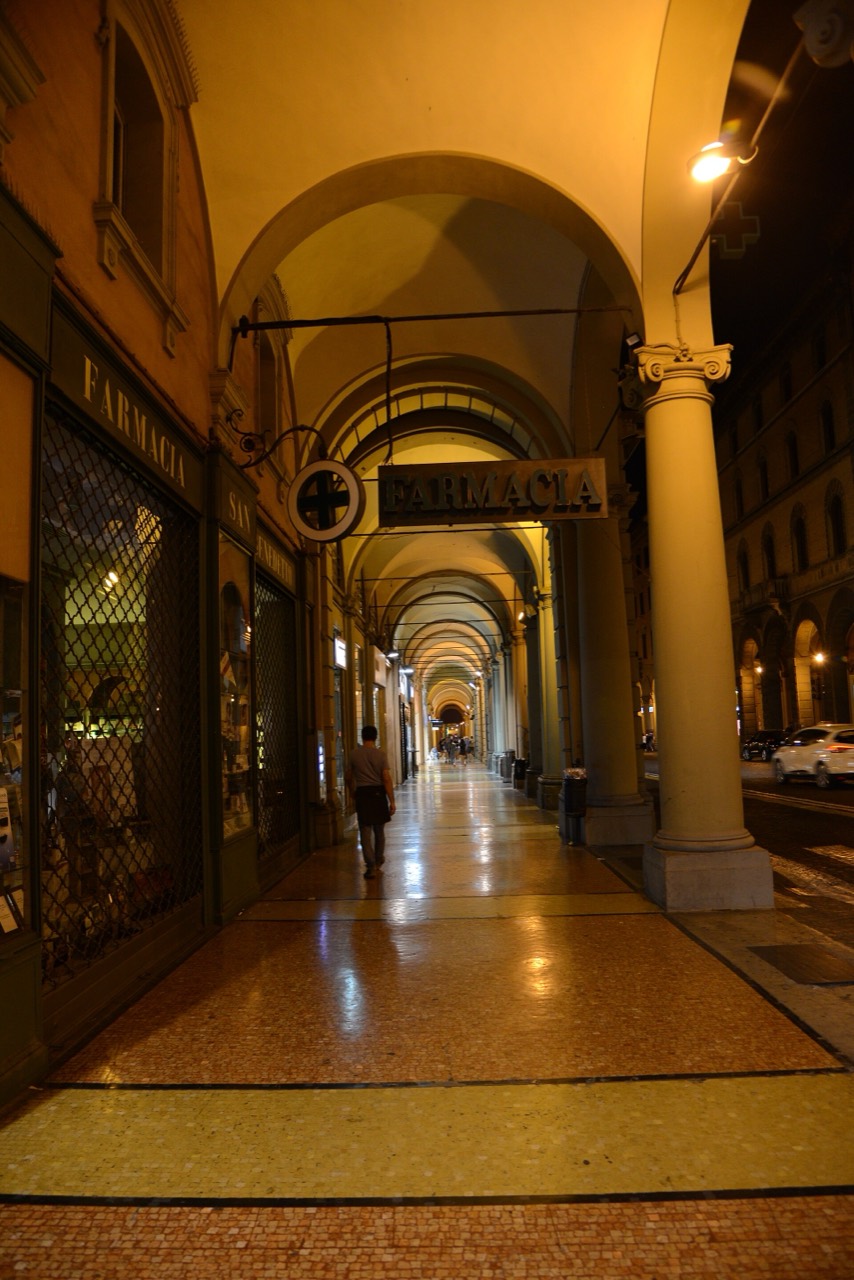 The lamplit porticoes of Bologna at night